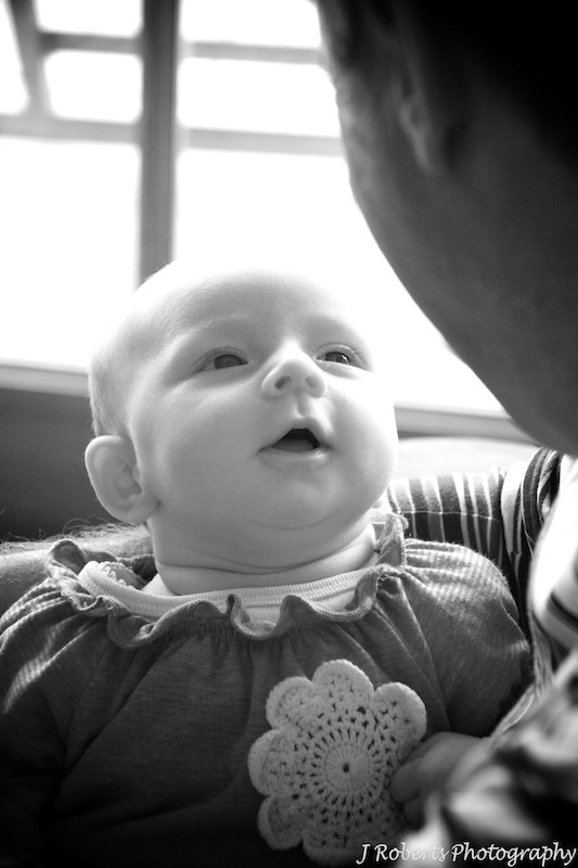 Little baby talking to daddy - family portrait photography